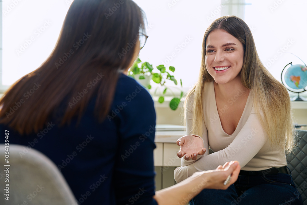 Happy young woman at therapy with female professional psychologist Happy young woman at therapy with female professional psychologist