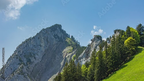 Time lapse, paragliders flying over the mountains. Urmiberg, Rigi Hochflue, Canton Schwyz, Switzerland.