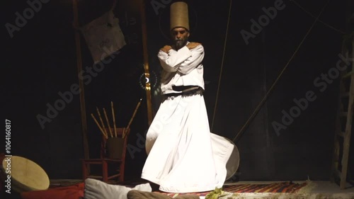 the image of a whirling Dervish in the darkness