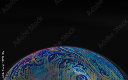 macro drawing of the earth on a hemisphere in a soap bubble on a black background, empty space for an inscription, ecology