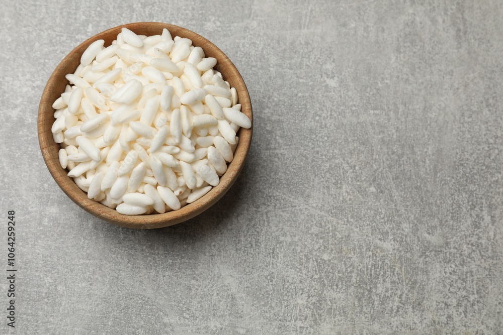 Puffed rice in bowl on light grey table, top view. Space for text Puffed rice in bowl on light grey table, top view. Space for text
