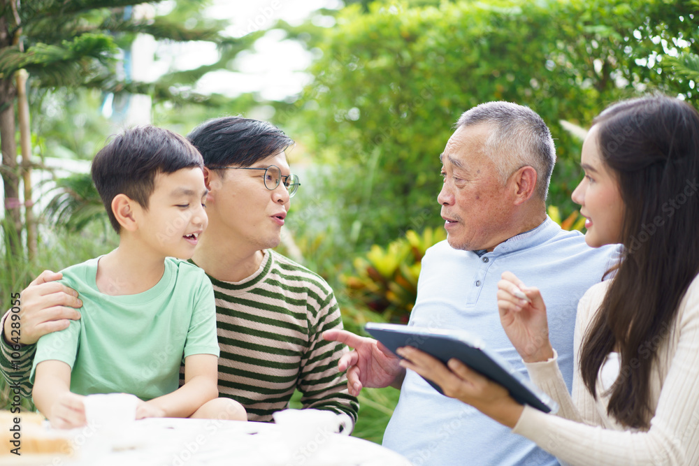 Multi generation Asian family relaxing in backyard garden together. Multi generation Asian family relaxing in backyard garden together.