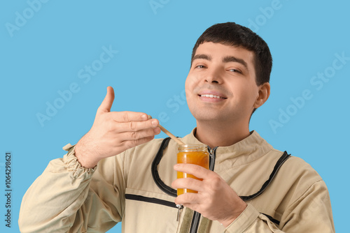 Male beekeeper with jar of ...