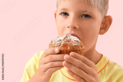 Little boy eating tasty muf...