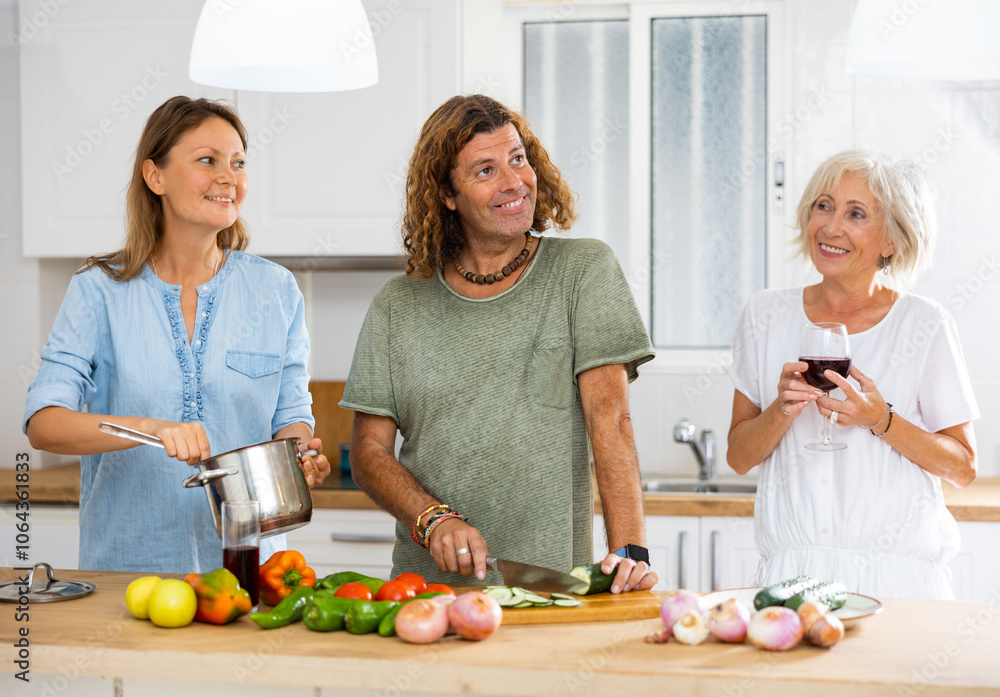 Happy family together with elderly mother preparing lunch in modern kitchen Happy family together with elderly mother preparing lunch in modern kitchen