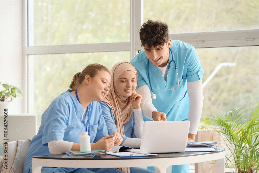 Medical students studying with laptop on table at university Medical students studying with laptop on table at university
