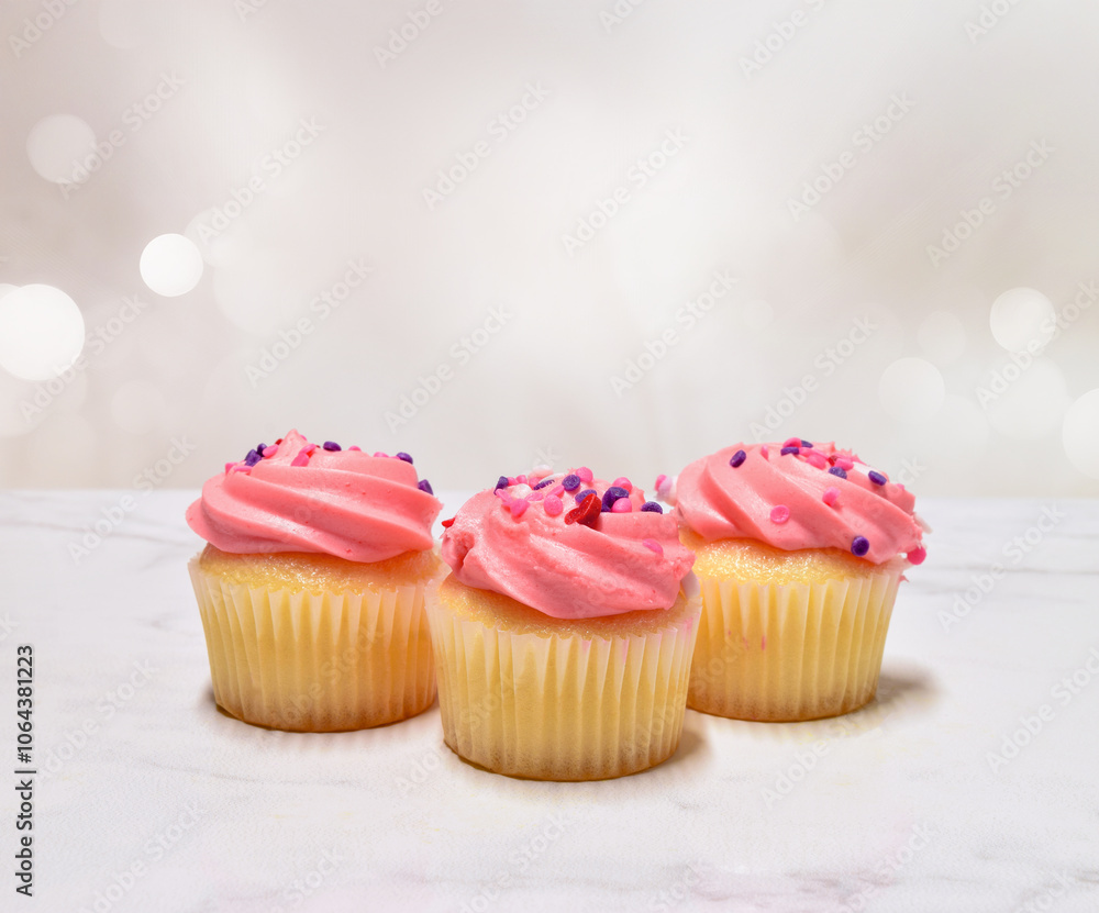 Sweet frosted pink cupcakes with sprinkles with copy space Sweet frosted pink cupcakes with sprinkles with copy space