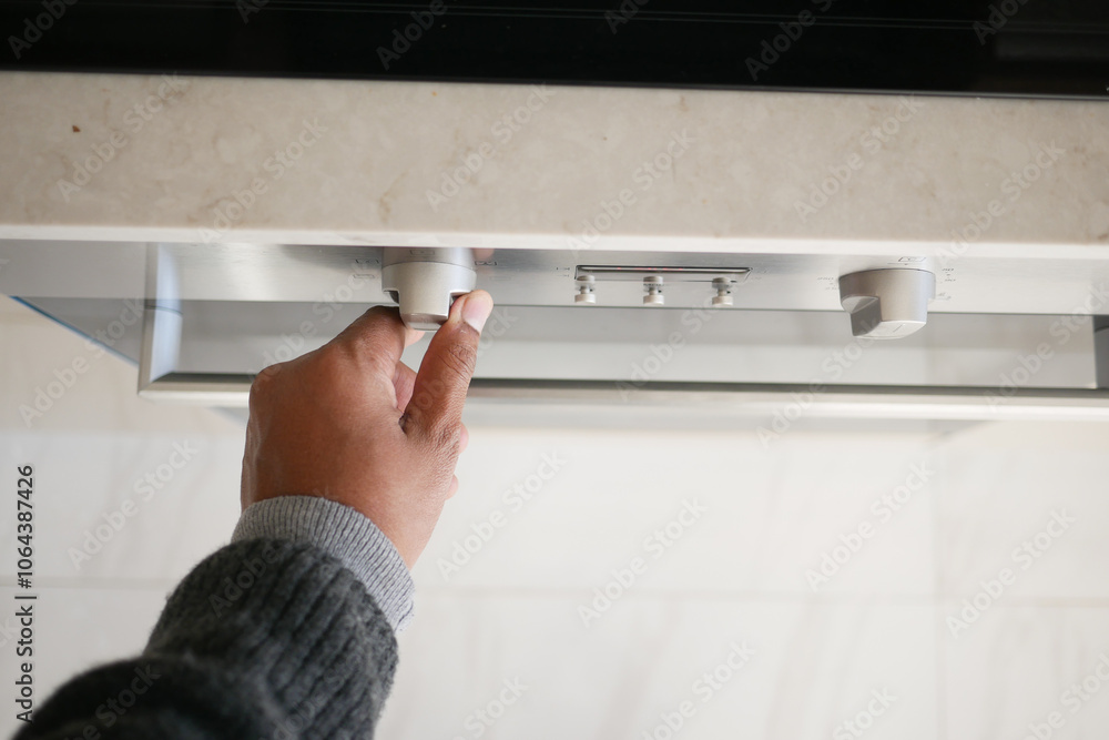 Close up of men hand setting temperature control on oven. Close up of men hand setting temperature control on oven.