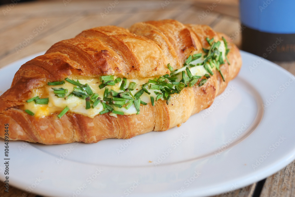 Amouthwatering and delicious Croissant Sandwich filled with Fresh Herbs and Eggs Amouthwatering and delicious Croissant Sandwich filled with Fresh Herbs and Eggs