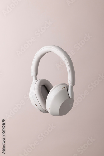 white headphones background on the pink