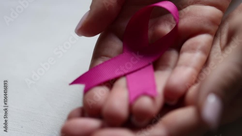 Wallpaper Mural Female hands holding a pink ribbon, closeup Torontodigital.ca