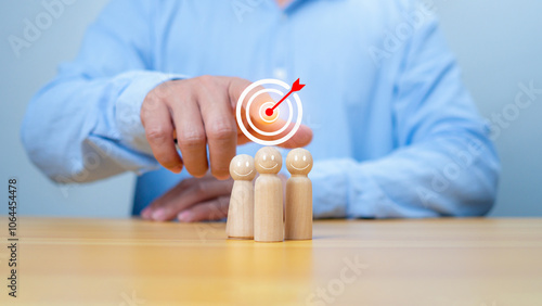 Business achievement goal and objective target, Team growing business success concept, Teamwork, Successful team, Hand holding dartboards target and human icon with line connection on wooden block. photo