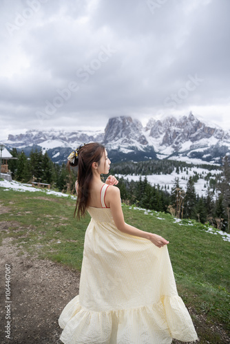 Woman vacation in Alpe di Siusi mountain group in Dolomites, Italy.