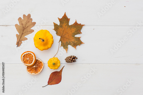 Autumn holiday frame composition with pattern made of leaf, punpkins, dried orange, pine cone on white wooden background. thanksgiving day, halloween eco zero waste concept. Minimal flat lay, top view photo