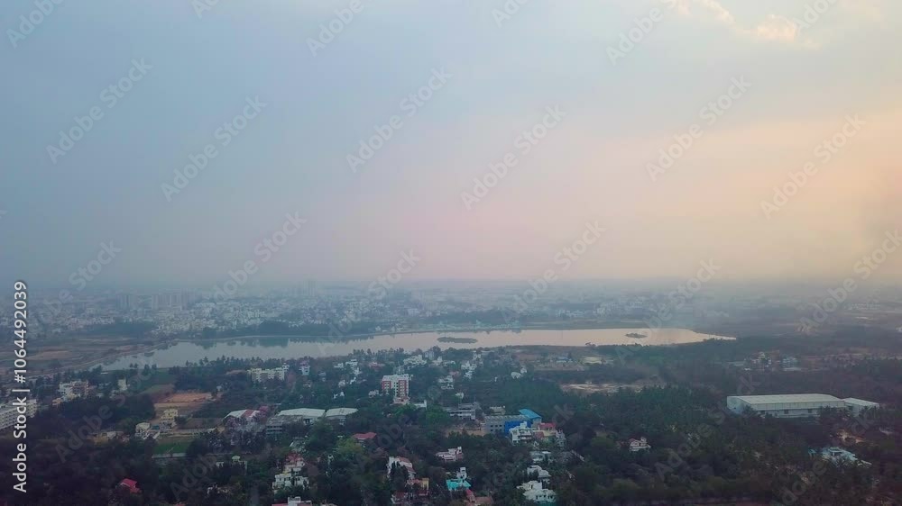 Pull back aerial shot of Bangalore city covered in greenery and Kalkere Lake in Karnataka, India. Pull back aerial shot of Bangalore city covered in greenery and Kalkere Lake in Karnataka, India.