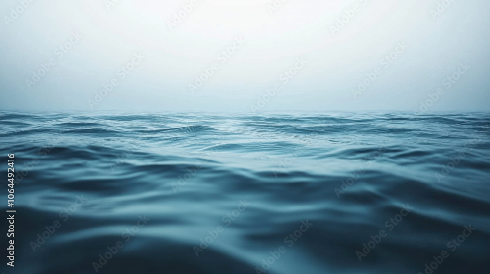 Fototapeta premium serene view of calm ocean waves under soft, misty horizon, evoking tranquility and peace. gentle ripples create soothing atmosphere