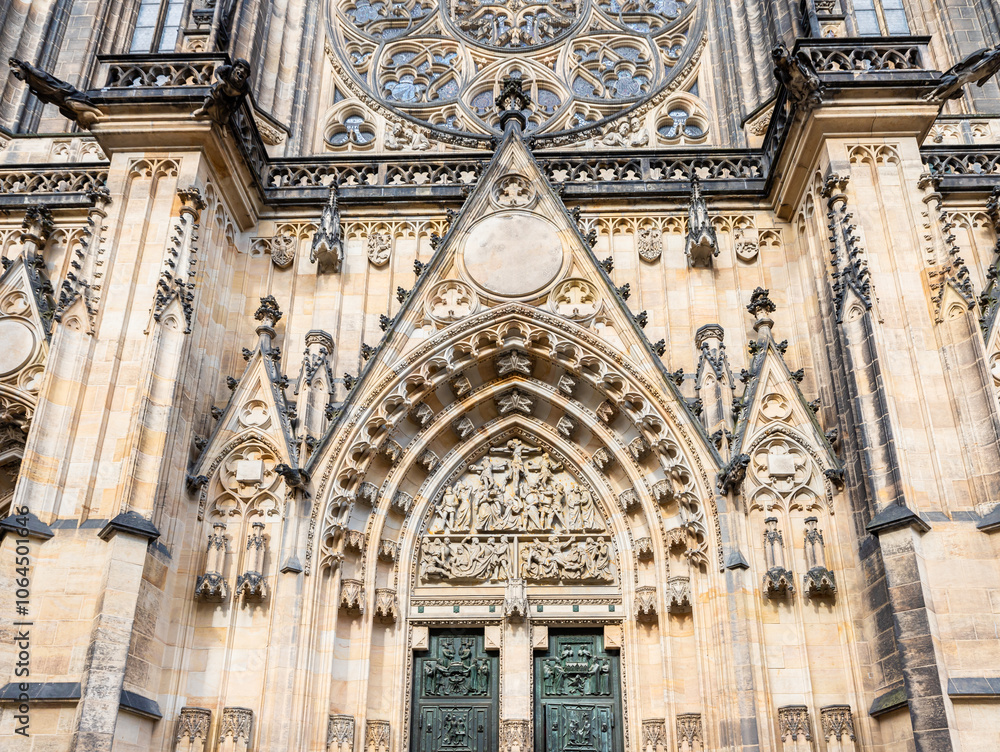 Fototapeta premium The bottom part of main facade of St Vitus Cathedral near New Royal Palace in Prague in Czech Republic