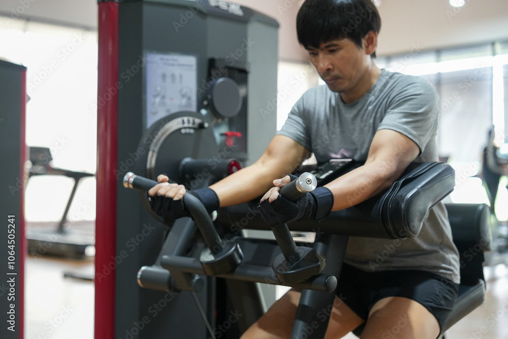 Man exercising train your arm muscles in gym. Man exercising train your arm muscles in gym.