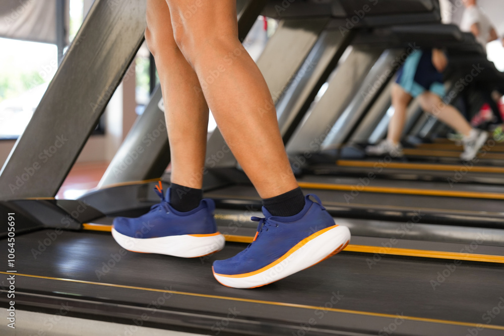Close up man feet running on the treadmill at the gym. Cardio exercise Close up man feet running on the treadmill at the gym. Cardio exercise