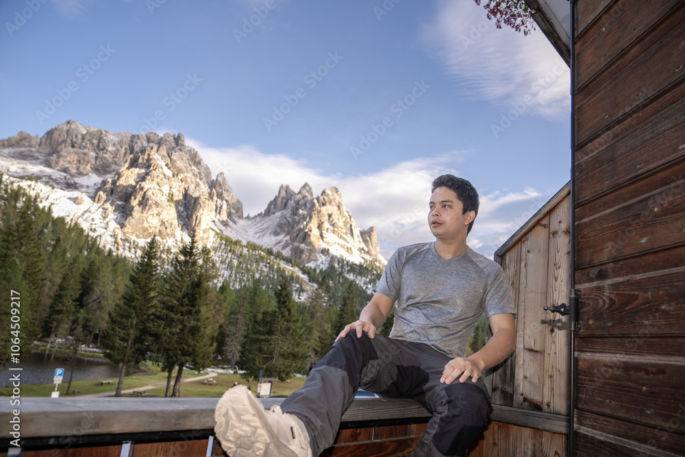 Man enjoy view of mountain peak from Lake Antorno (Lago di Antorno) located in Dolomites, Italy. Man enjoy view of mountain peak from Lake Antorno (Lago di Antorno) located in Dolomites, Italy.
