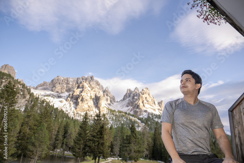 Man enjoy view of mountain peak from Lake Antorno (Lago di Antorno) located in Dolomites, Italy.