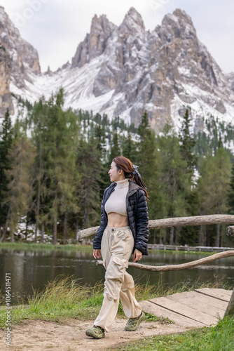 Woman enjoy view of Mountain peak from Lake Antorno (Lago di Antorno) located in Dolomites, Italy.