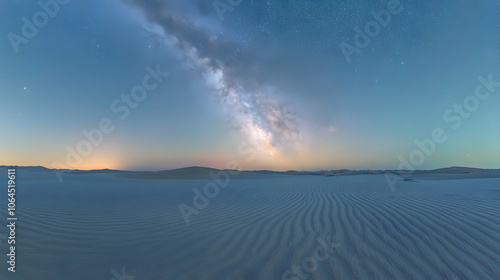 Milky Way galaxy over white sand dunes in a desert landscape.