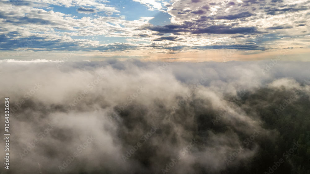 Obraz premium Flying above the clouds at dawn in autumn