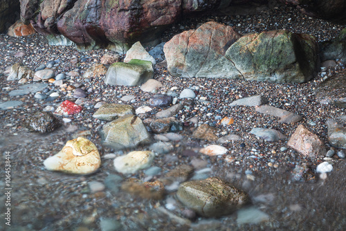 rocks and pebbles at beach on broughton island hawks nest nsw australia photo