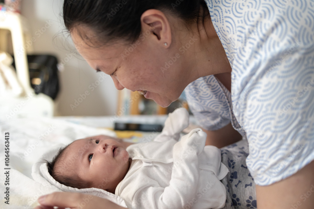 Portrait of a beautiful an Asian mother, with her nursing baby Portrait of a beautiful an Asian mother, with her nursing baby