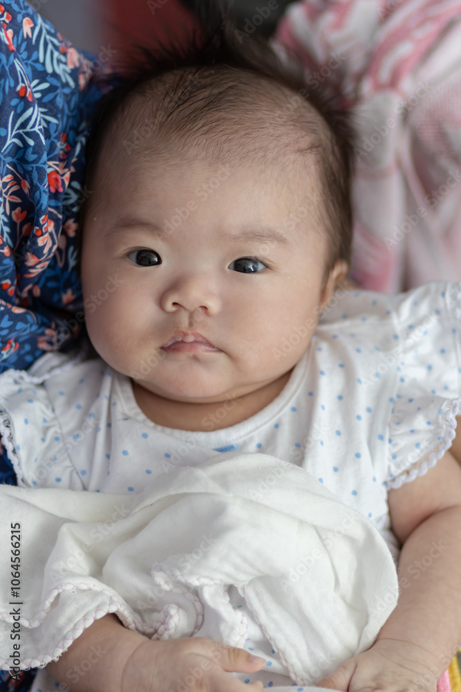 Happy Smiling face Asian Chinese baby girl during lying on bed. Happy Newborn child relaxing in bed Happy Smiling face Asian Chinese baby girl during lying on bed. Happy Newborn child relaxing in bed
