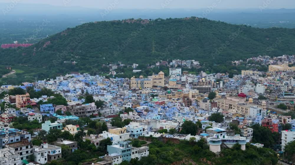 Aerial View of Crowded Blue City Houses at Mountain Base in the Evening Aerial View of Crowded Blue City Houses at Mountain Base in the Evening