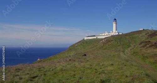 extra wide shot looking West onto the Mull of Galloway lighthouse and foghorn with fields in foreground photo