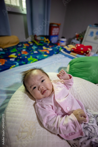 Close-up Portrait image of 3 month old baby girl of Asian Chinese child on happy mode photo