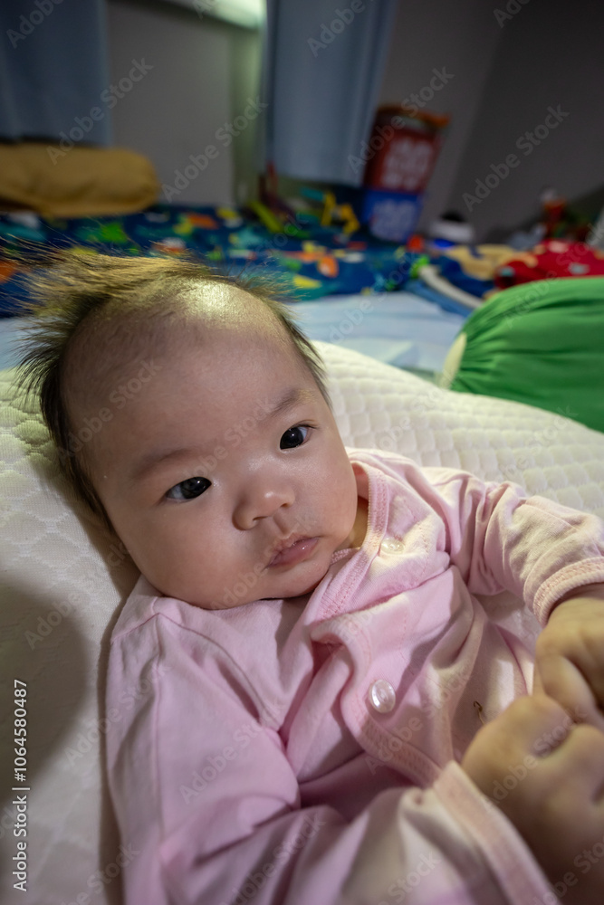 Close-up Portrait image of 3 month old baby girl of Asian Chinese child on happy mode Close-up Portrait image of 3 month old baby girl of Asian Chinese child on happy mode