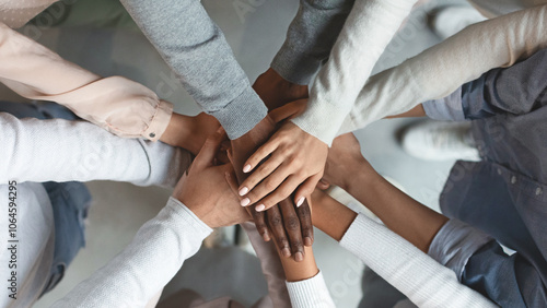 Close up of international business team showing unity with putting their hands together on top of each other. Concept of teamwork, top view photo