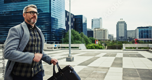 Mature, businessman and running late in city for meeting as real estate agent for morning commute. Male person, outdoor and realtor for transport, travel and career as property investment in Scotland photo