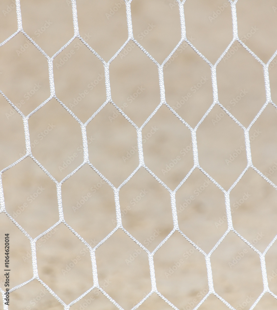 Fototapeta premium A white mesh with a pattern of squares and triangles