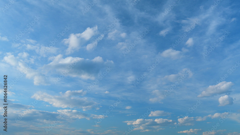 Obraz premium Background of clouds and sky on a sunny day. Light blue and white colours of real skies with clouds. Time lapse.