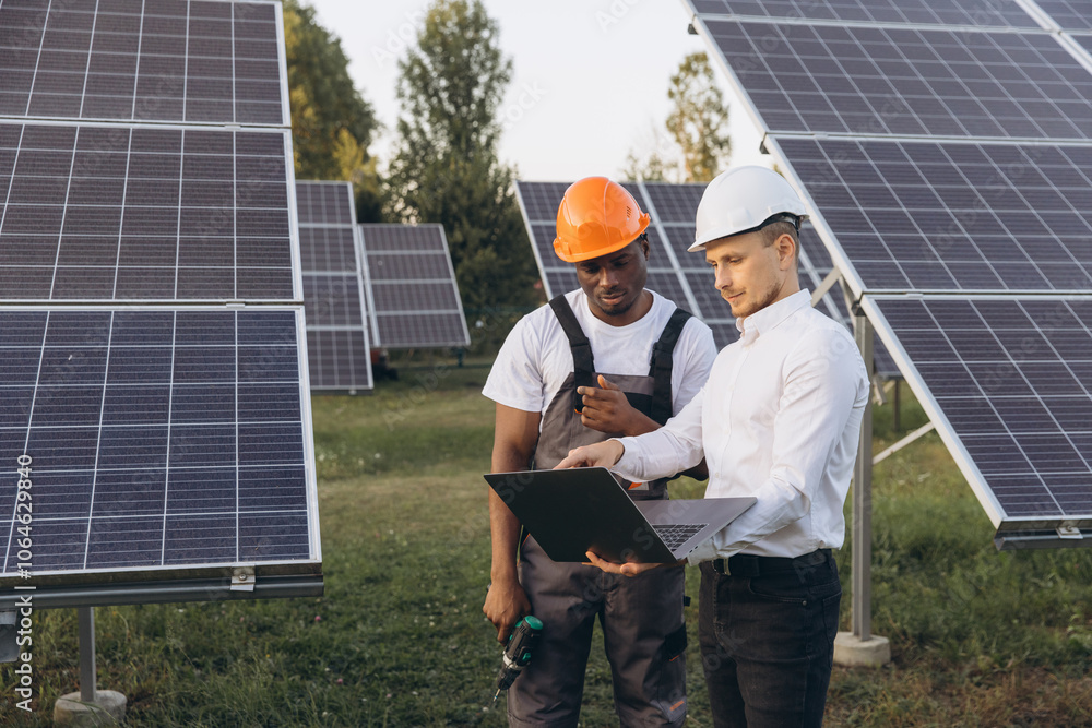 Engineers Discussing Solar Panel Installation at a Renewable Energy Site Engineers Discussing Solar Panel Installation at a Renewable Energy Site
