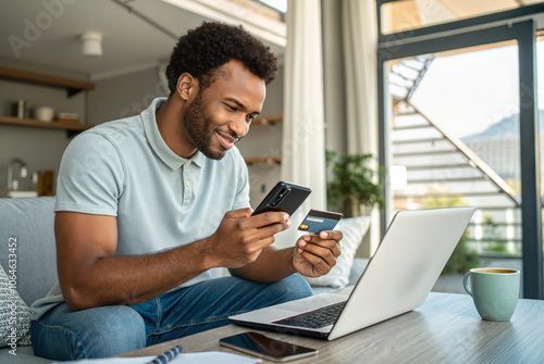 Man using smartphone and credit card for online shopping at home