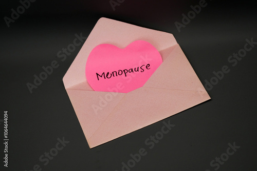 a heart-shaped letter with the words Menopause in a pink envelope