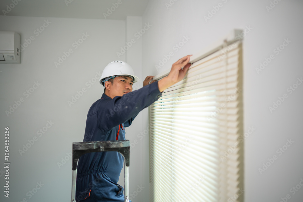 Worker with Hard Hat Installing Window Blinds in Residential Interior Worker with Hard Hat Installing Window Blinds in Residential Interior