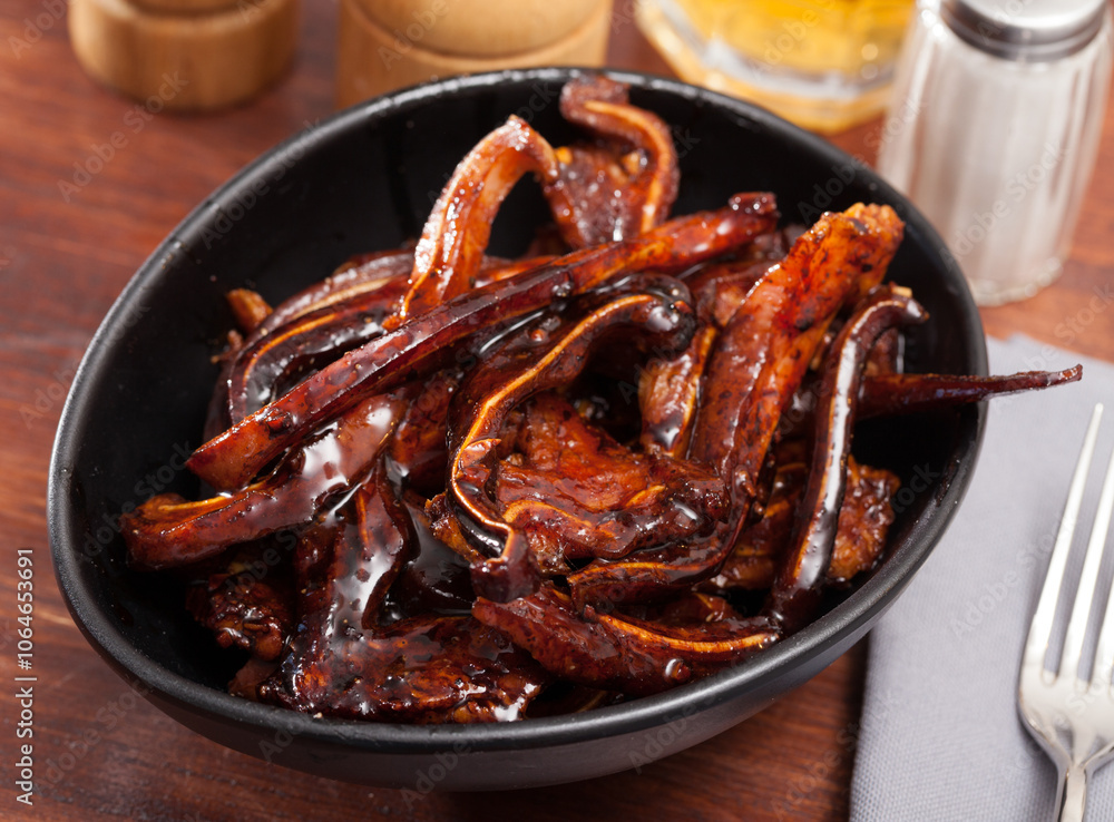 Appetizing Korean pork ears served in black bowl Appetizing Korean pork ears served in black bowl