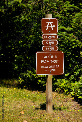 Signs on the Cascadia Marine Trail, Puget Sound, an instruction to Pack It In, Pack It Out, to keep the trail clear and unspoilt  photo