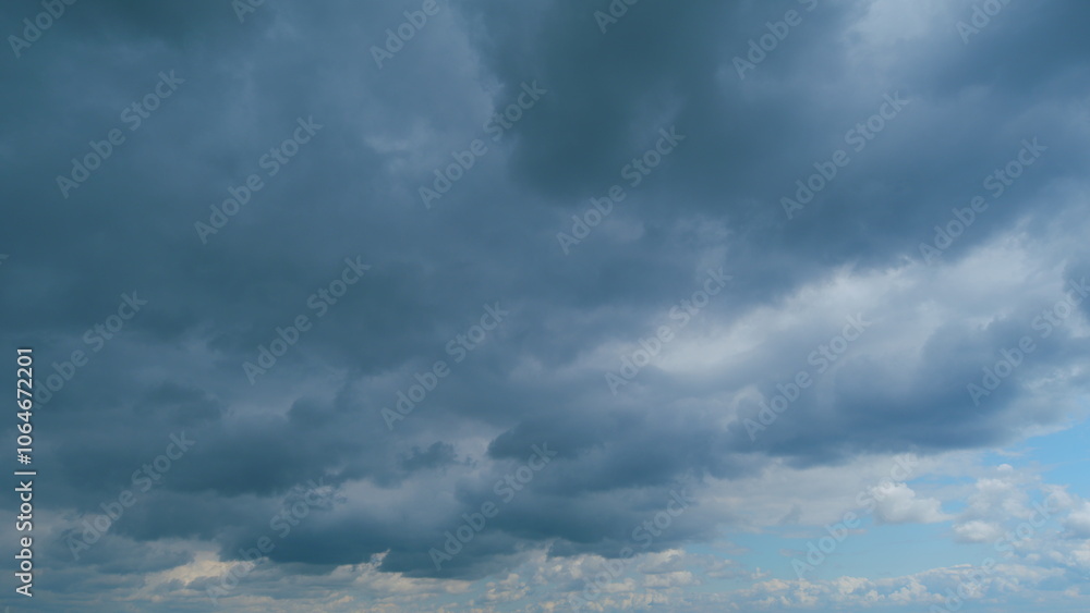 Fototapeta premium Sky with white fluffy rain clouds on the blue sky. Dramatic cloudscape, amazing sky. Time lapse.