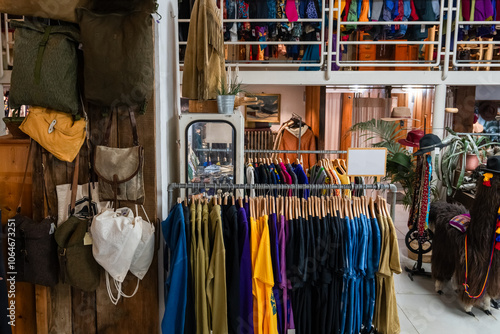 A lot of vintage and fashionable clothes in a second-hand store for recycling or resale to preserve the environment photo