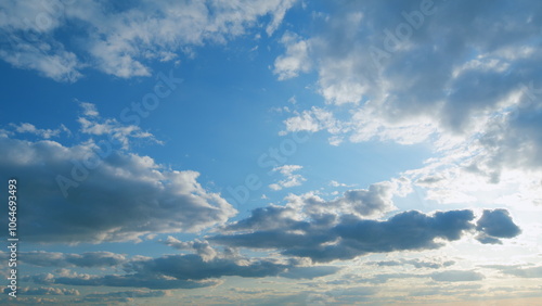 Beautiful blue sky with sunbeams and clouds. Clouds at blue sky background. Sunny cloudscape. Timelapse.