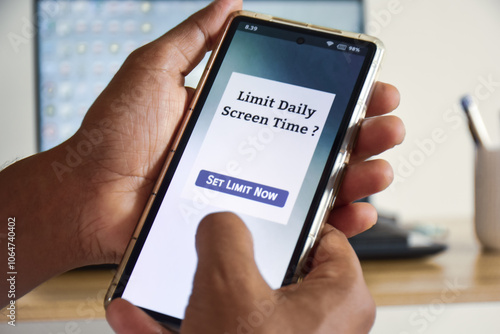 Man setting up screen time limit on his mobile phone. Digital wellbeing concept, selective focus.