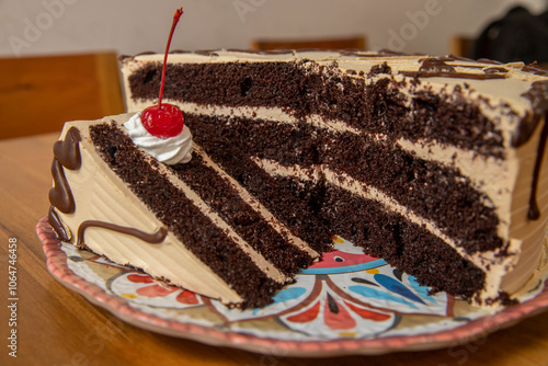 Torta de chocolate rellena de crema y cereza photo